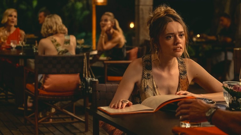Aimee Lou Wood at an outdoor dinner table in The White Lotus Season 3