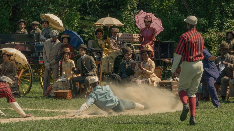 A runner slides in to home in an 1884 game of baseball in The Gilded Age season 3.