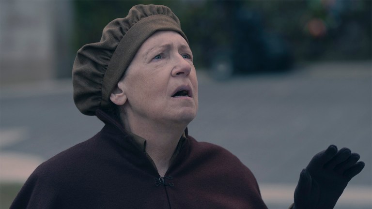 Ann Dowd wearing an Aunt's uniform and looking upset in The Handmaid's Tale season 6
