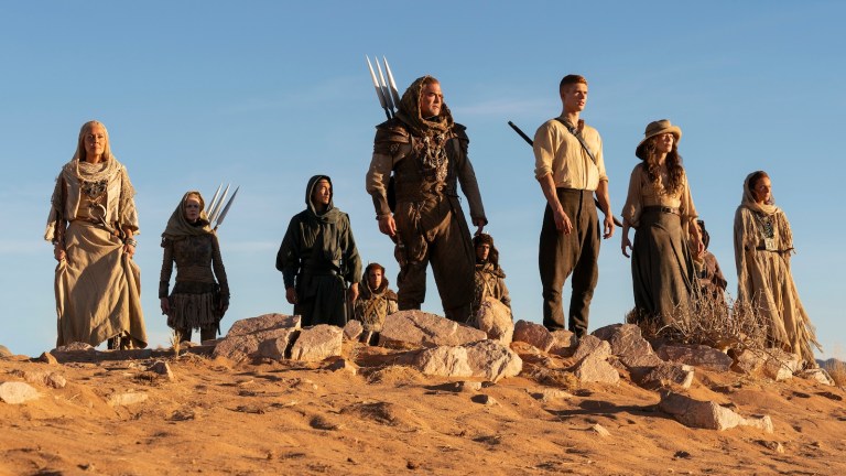 Rand, Moiraine, and the Aiel standing in the desert in The Wheel of Time